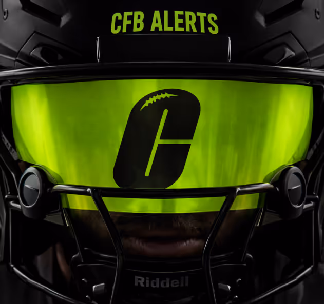 Close-up of a football helmet with a green reflective visor displaying a stylized 'C' with a football design, and 'CFB ALERTS' text above.
