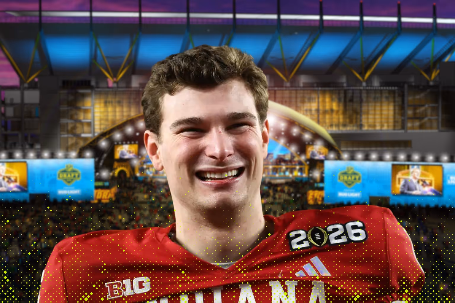 Smiling football player wearing red Indiana jersey with 2026 patch in a stadium with bright lights and crowd.