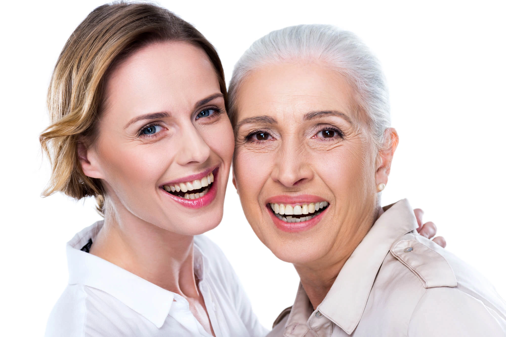 Smiling young woman and older woman posing closely against a white background.