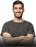 Smiling young man with short dark hair and a mustache, wearing a gray t-shirt and crossing his arms.