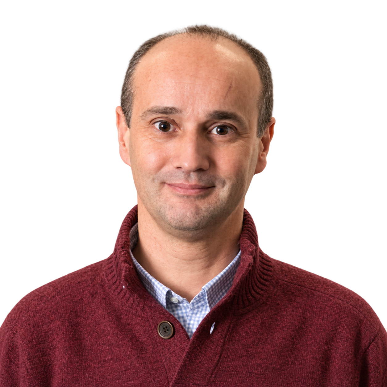 Oscar de Oliveira smiling in a burgundy sweater