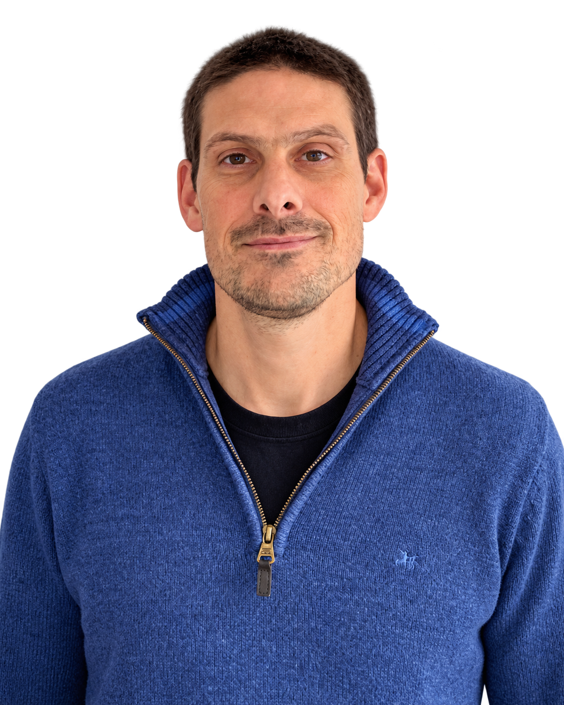 Diego Bouvier facing the camera, wearing a blue zip-up sweater.