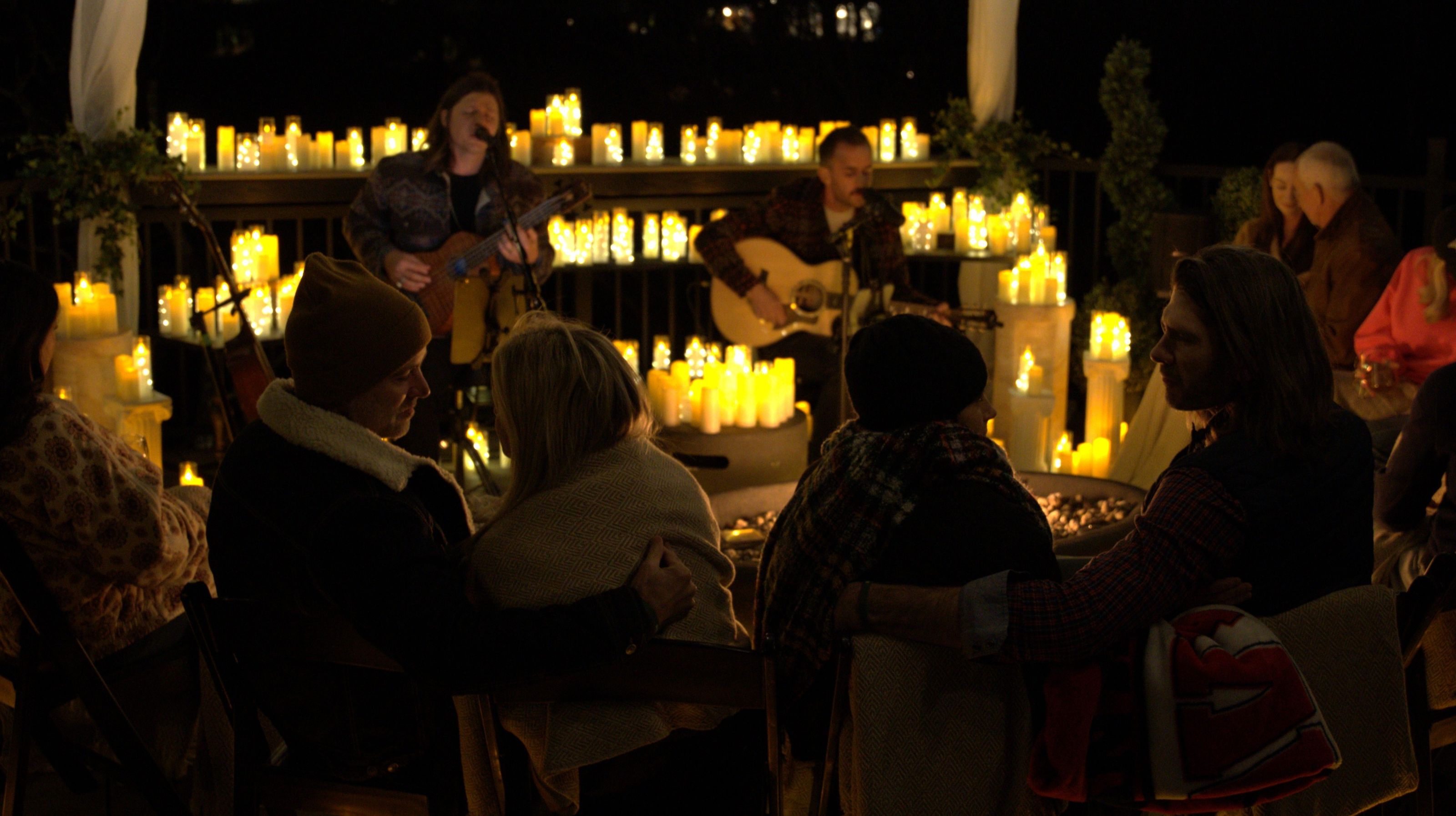 Seth Bolt welcoming guests under the Bolt Farm sign with candles glowing