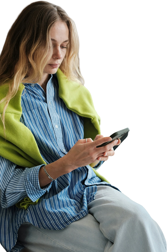 Professional woman in blue striped shirt and green blazer using mobile phone