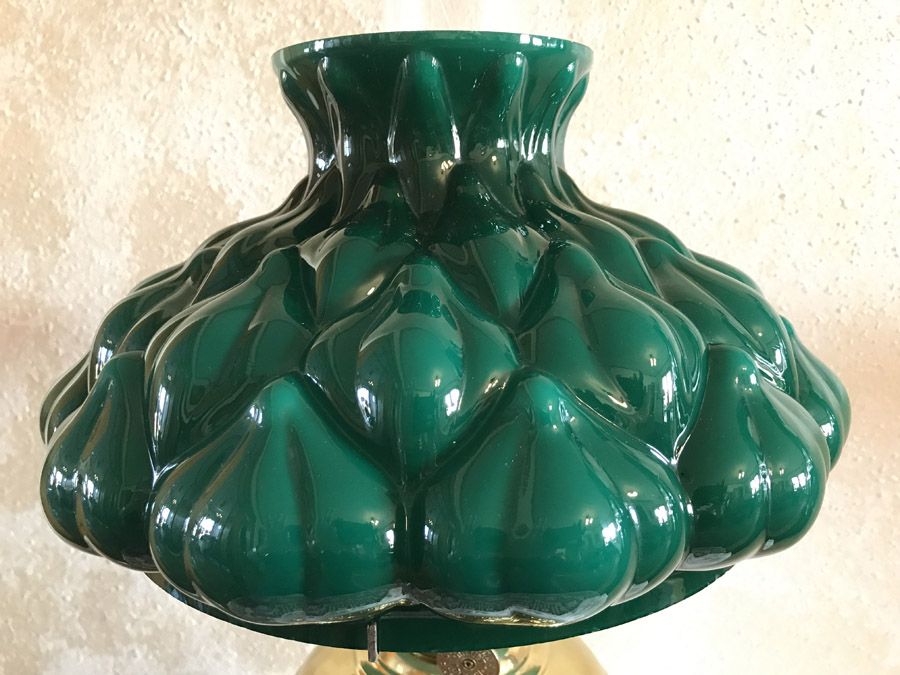 Green glass lampshade with bulbous, leafy pattern and glossy finish.
