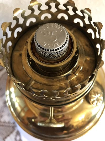 Top view of a vintage brass oil lamp burner with perforated metal cap marked No 5.