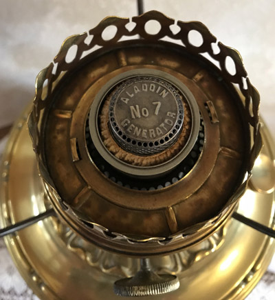 Close-up of an antique Aladdin No 7 Generator burner on a brass oil lamp.
