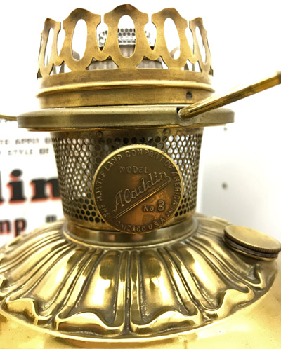Close-up of vintage brass Aladdin Model No. 8 oil lamp burner with perforated chimney.
