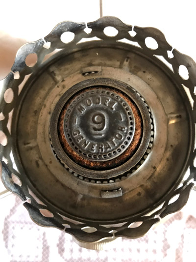 Top view of a vintage Model 9 generator part with a circular metal structure and rust spots.
