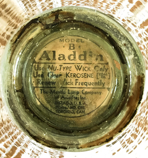 Close-up of a vintage Aladdin Model B lamp wick label with usage and kerosene instructions.