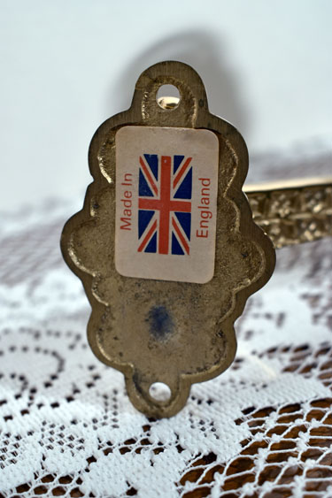 Close-up of a metal item with a label showing a Union Jack and text 'Made In England'.