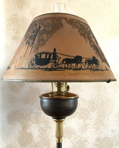 Vintage lamp with a horse-drawn carriage silhouette design on the lampshade.