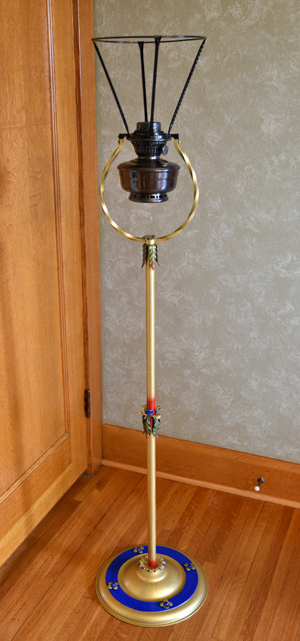 Tall vintage floor lamp with brass and blue base and ornate detailing, no lampshade.