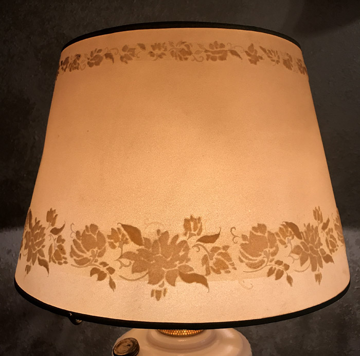 Orange lampshade with floral patterns along the top and bottom edges.