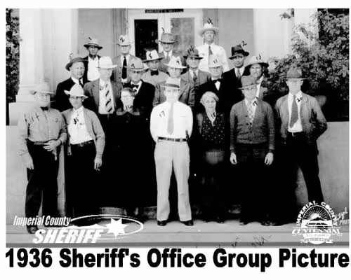Black and white 1936 group photo of Imperial County Sheriff's Office staff wearing hats, standing on steps outside a building.