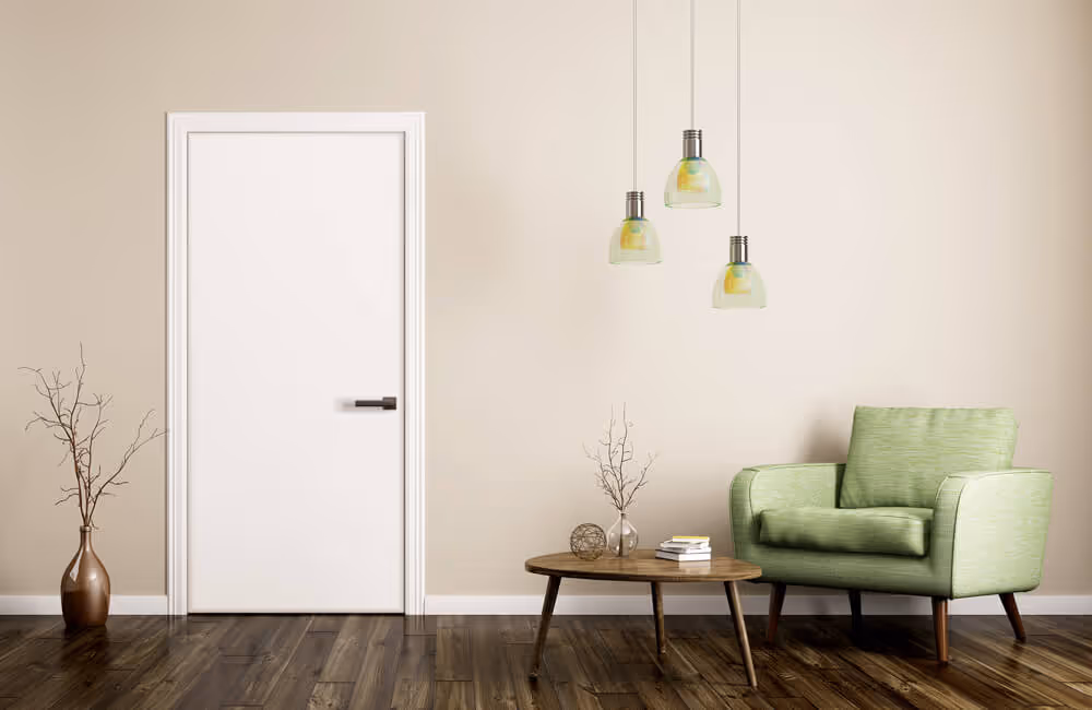 Minimalist room with a closed white door, green armchair, wooden coffee table with decor, and three pendant lights.