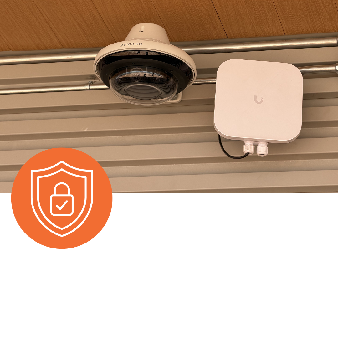 Small business owner with a VGI Technology security system protecting their storefront