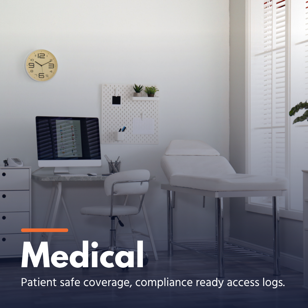 Modern medical exam room with an exam table, computer, chair, and clock on the wall.