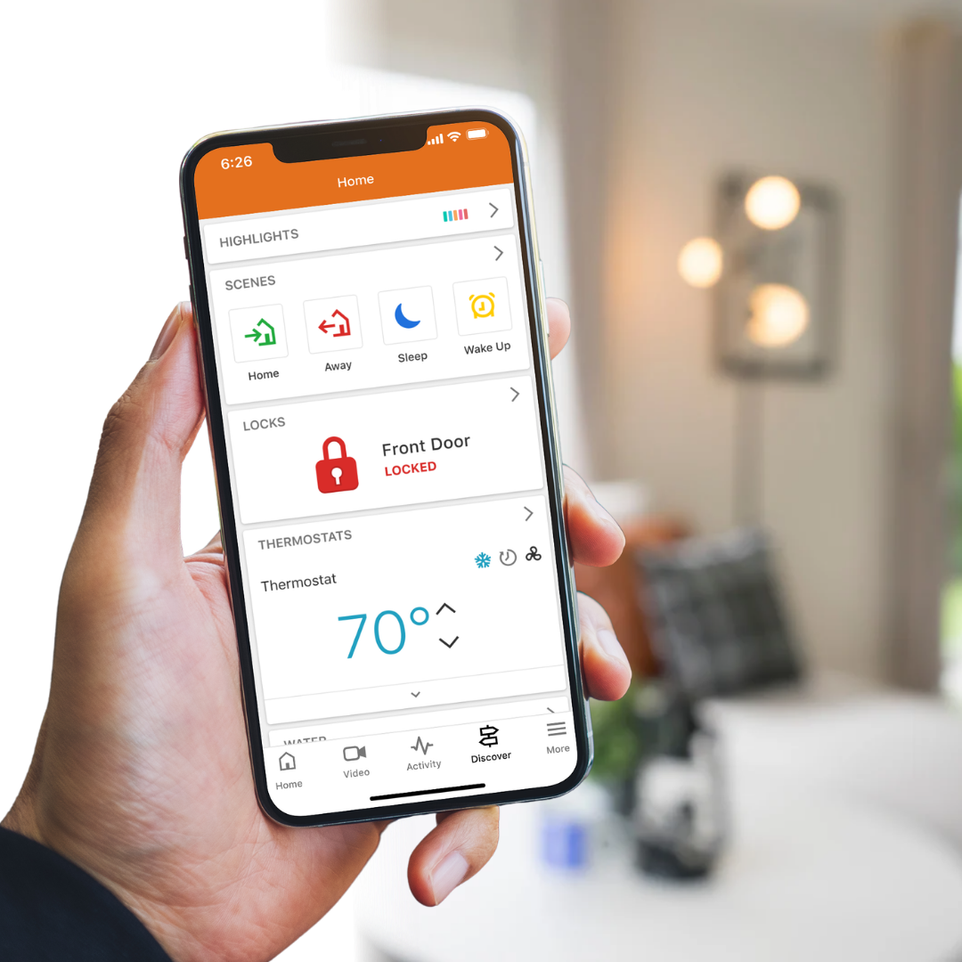 Hand holding phone showing smart home app with front door locked and thermostat set to 70 degrees.