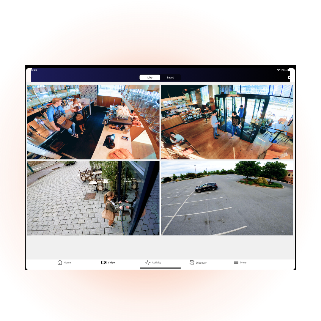 Security camera view showing coffee shop interior, customers, baristas, entrance, and a mostly empty parking lot.