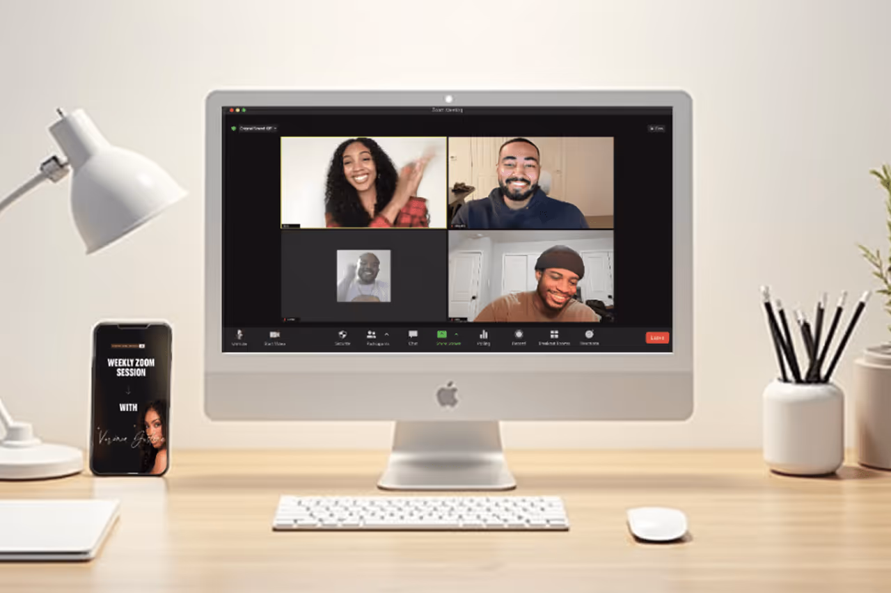Modern office workspace with a desktop computer showing an online meeting and a smartphone with a meeting reminder. 