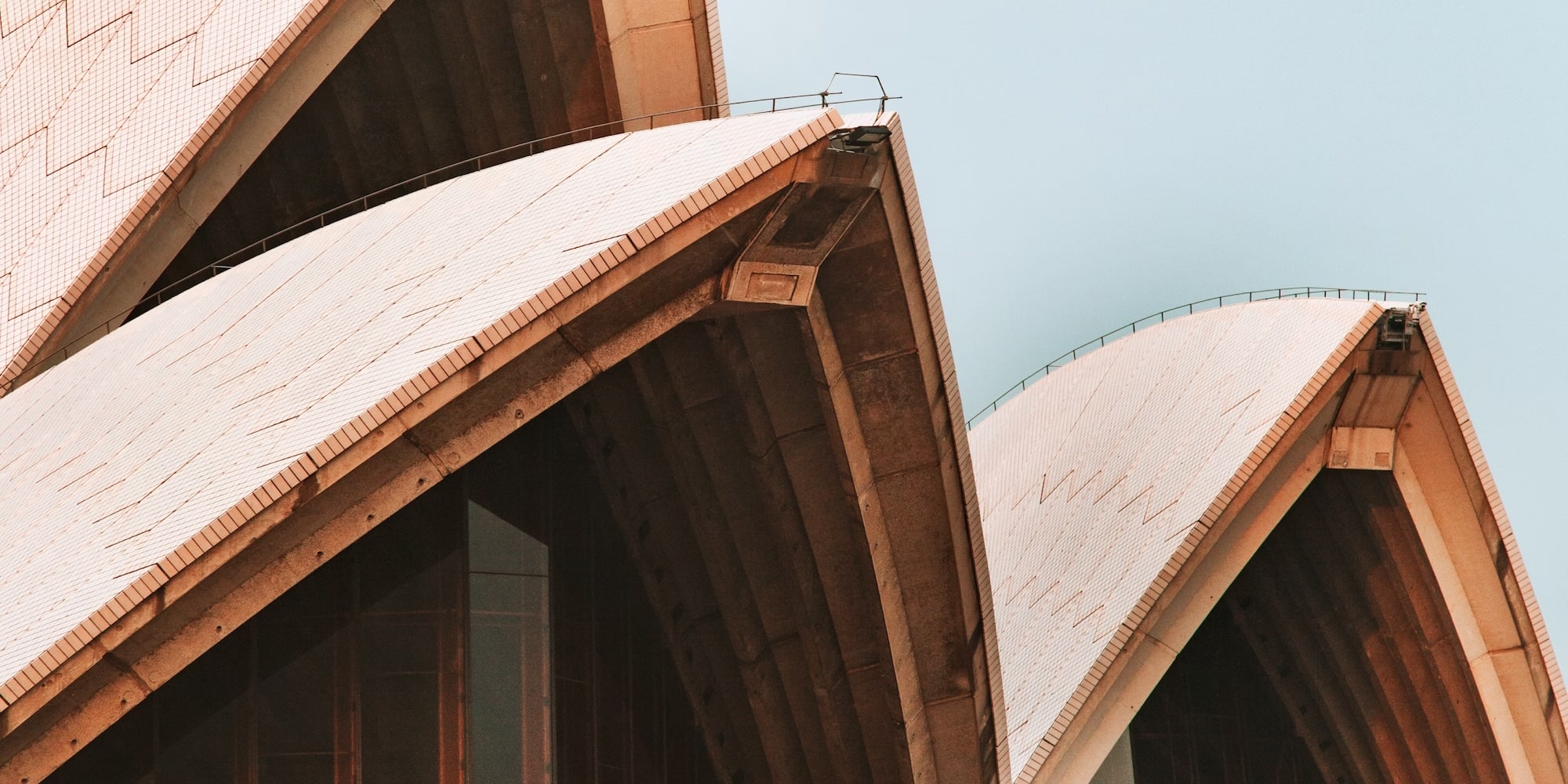 Close-up of the Sydney Opera House sails under a clear sky.