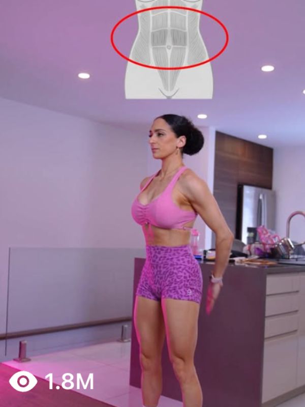 Worker wearing red safety helmet and harness standing on a bridge with a large structural beam overhead.