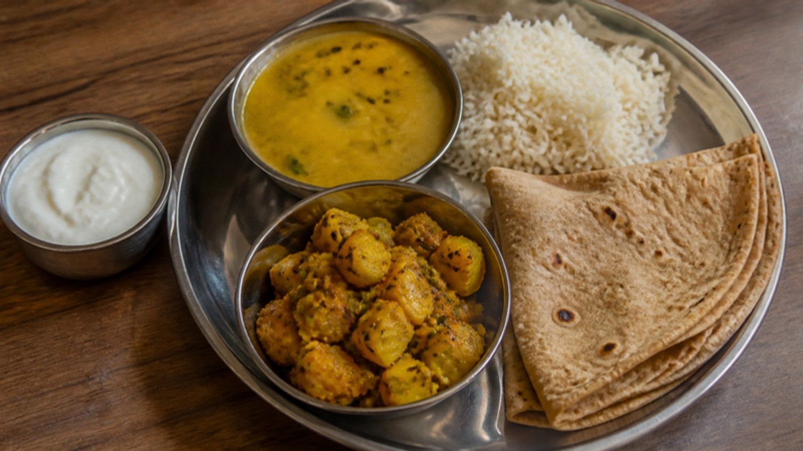 Indian thali with dal, sabzi, roti and a small bowl of curd