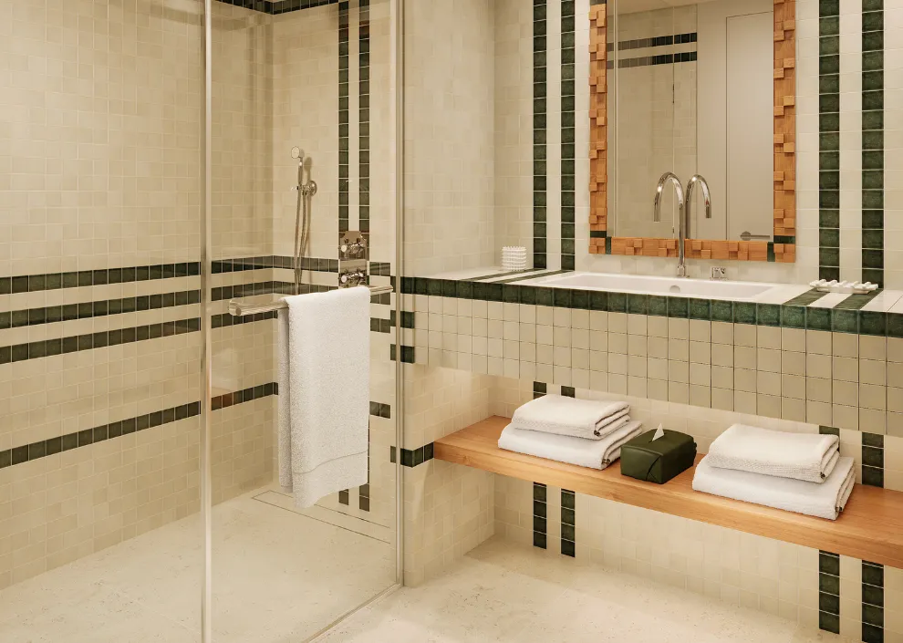 Design graphique aux Cimes Bleues : mosaïque verte et douche italienne dans les chambres, suites et salles de bain de votre hôtel au bord de mer et hôtel spa.