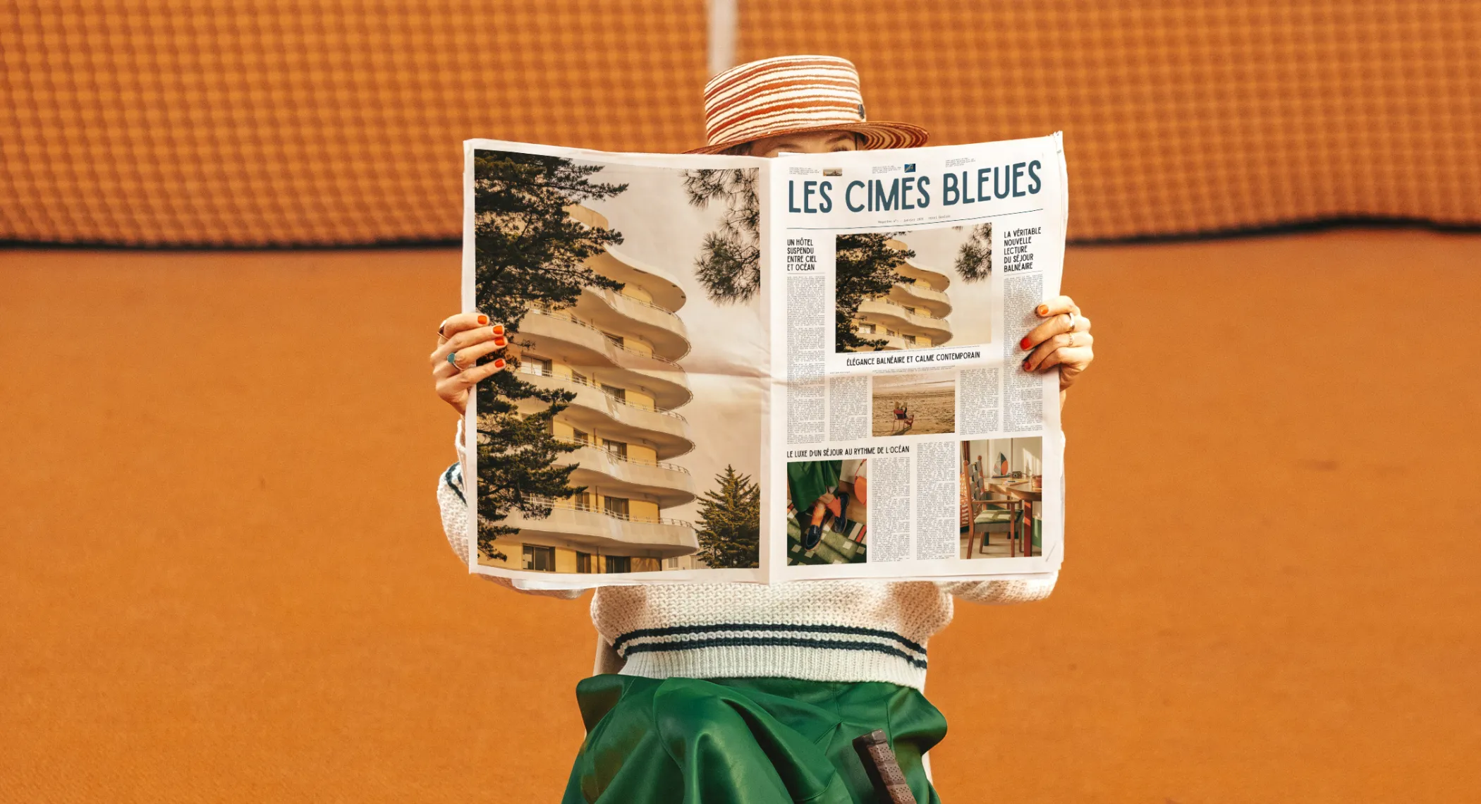 Chic relaxing break: woman reading the Les Cimes Bleues newspaper on clay, your spa hotel with comfortable rooms facing the ocean.
