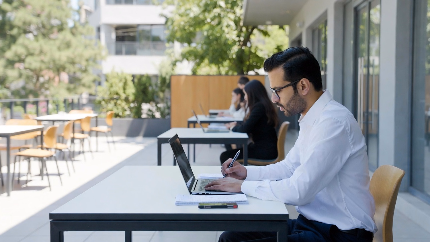 OUTDOOR TERRACE, one or two people working at a table on a sunny outdoor of