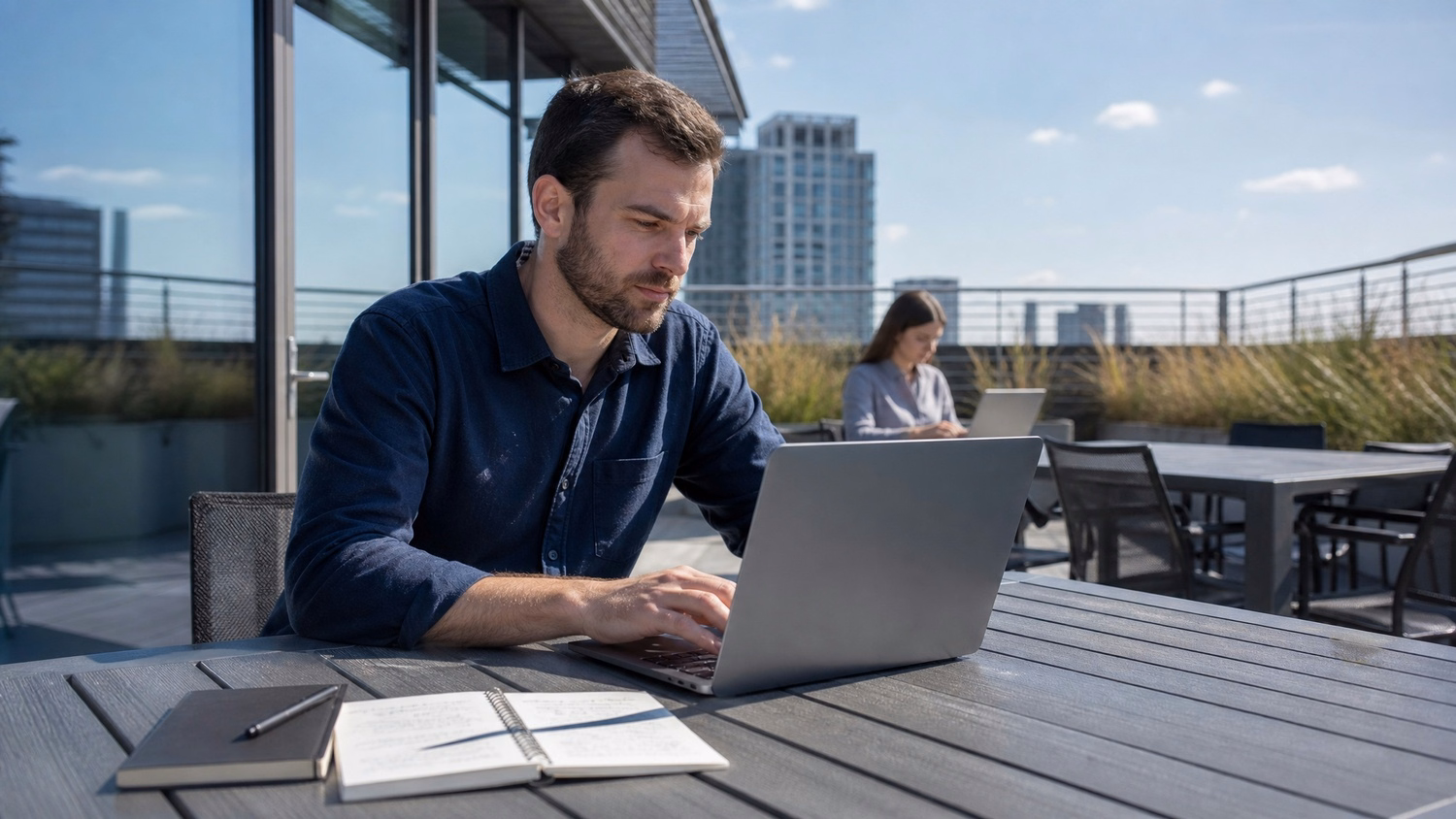 OUTDOOR TERRACE, one or two people working at a table on a sunny outdoor of