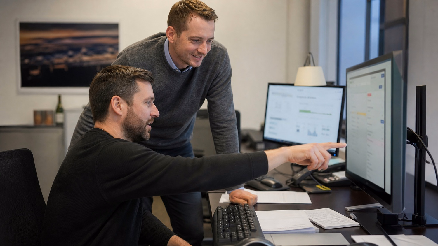 Colleagues review flagged email on computer screen 57