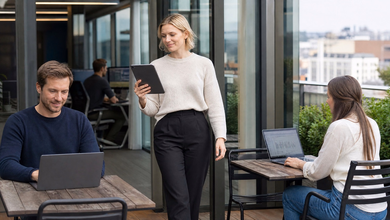Woman reviews tablet data on outdoor terrace cafe, workflow