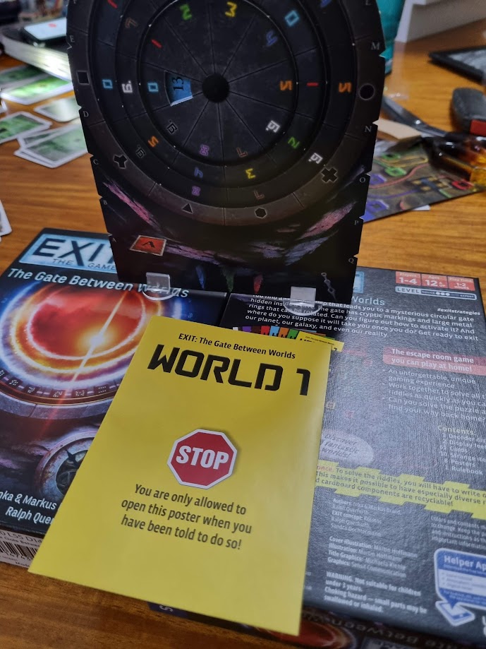 Gameplay photo of the board game EXIT: The Game – The Gate Between Worlds featuring various components and board state.