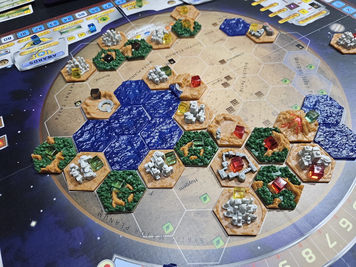 Gameplay photo of the board game Terraforming Mars: Hellas & Elysium featuring various components and board state.