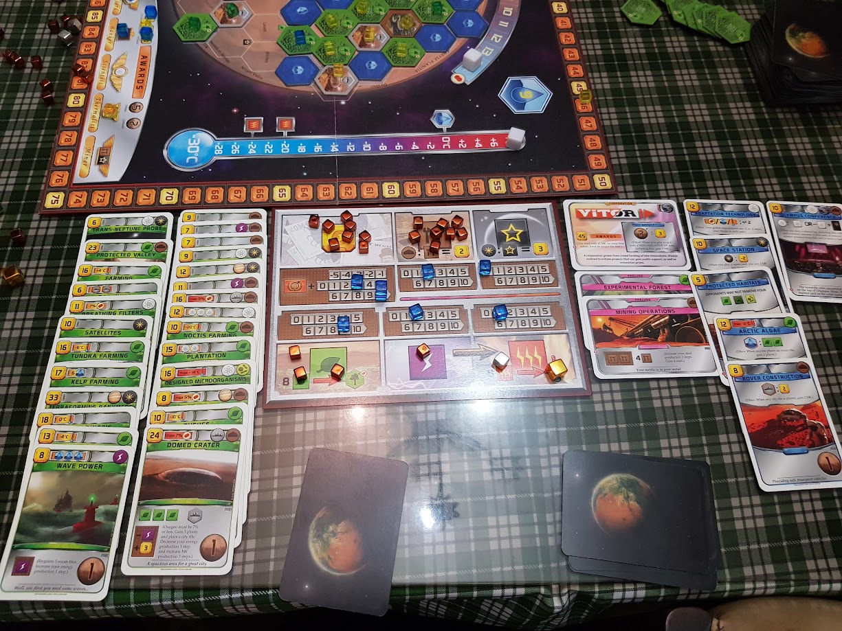 Gameplay photo of the board game Terraforming Mars: Prelude featuring various components and board state.