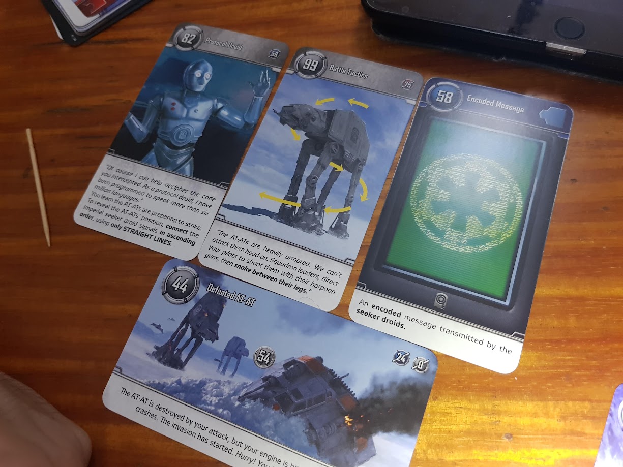 Gameplay photo of the board game Star Wars: Unlock! featuring various components and board state.