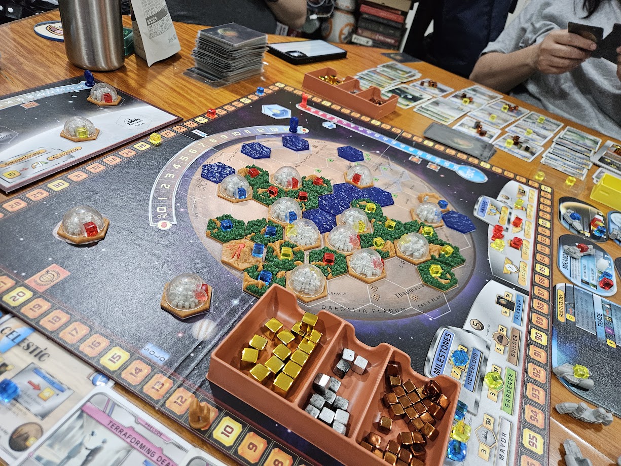 Gameplay photo of the board game Terraforming Mars: Venus Next featuring various components and board state.
