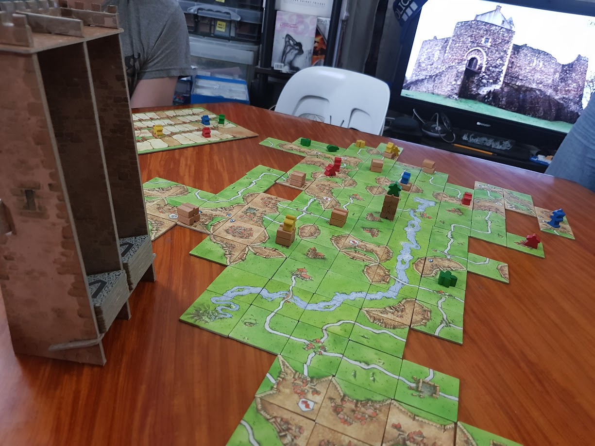 Gameplay photo of the board game Carcassonne: The Tower featuring various components and board state.