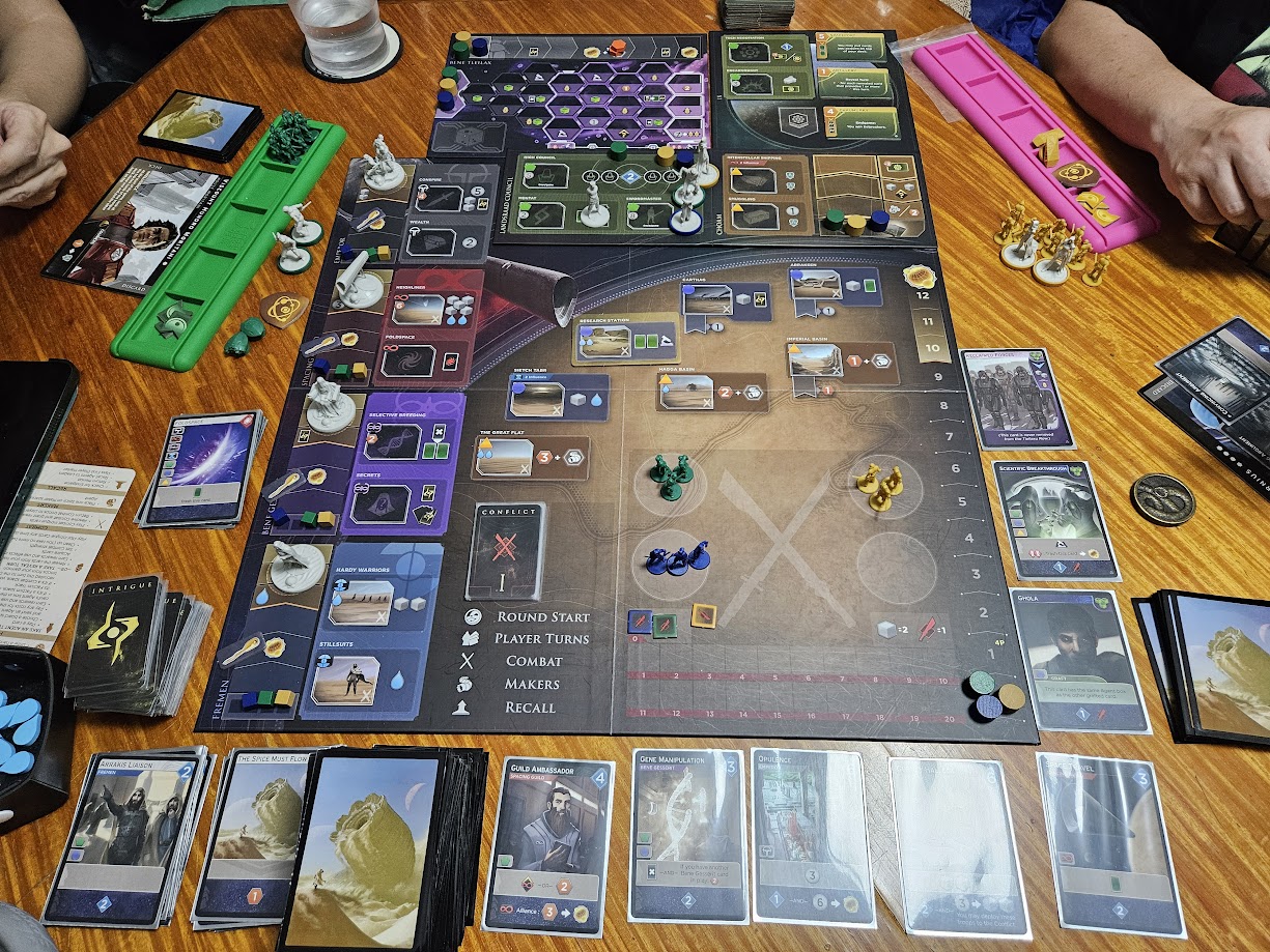 Gameplay photo of the board game Dune: Imperium – Immortality featuring various components and board state.