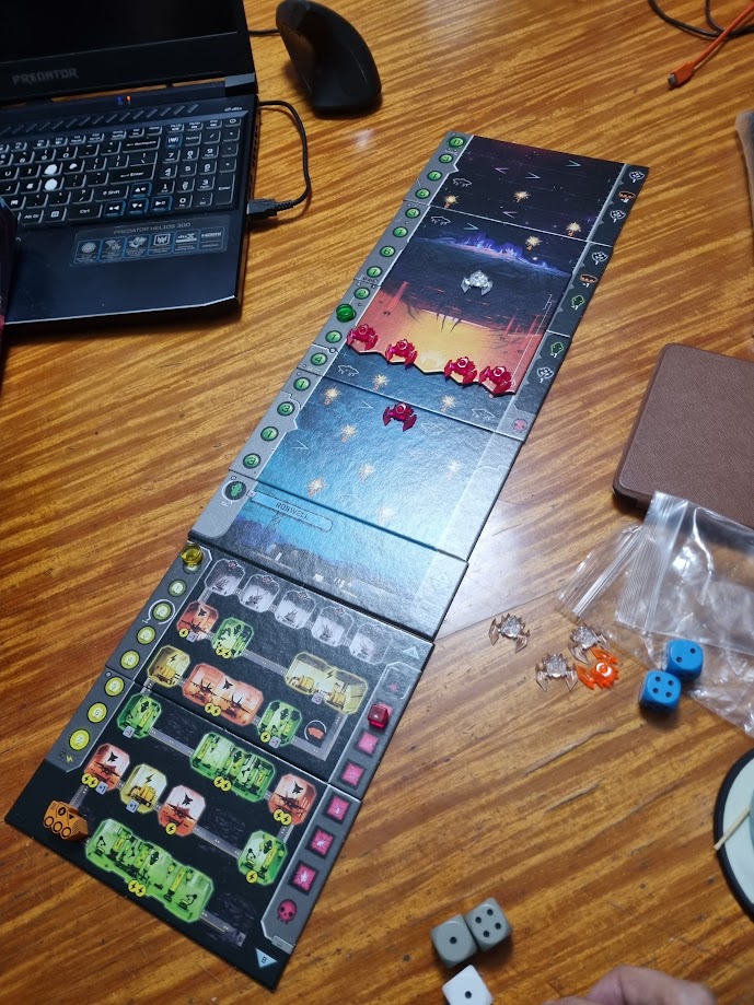 Gameplay photo of the board game Under Falling Skies featuring various components and board state.