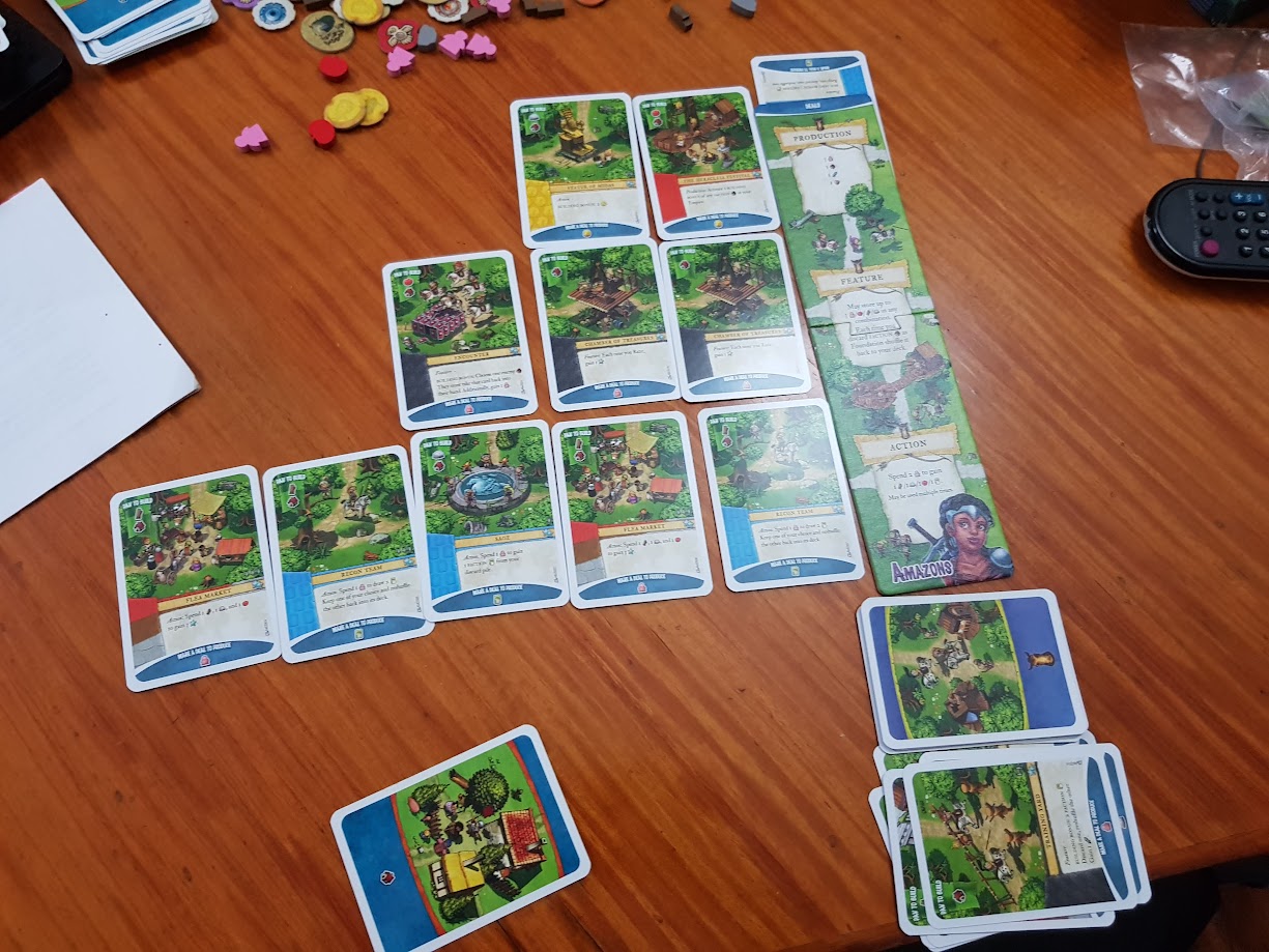 Gameplay photo of the board game Imperial Settlers: Amazons featuring various components and board state.