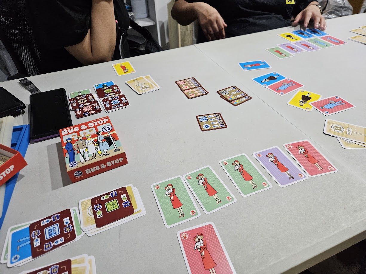Gameplay photo of the board game Bus & Stop featuring various components and board state.
