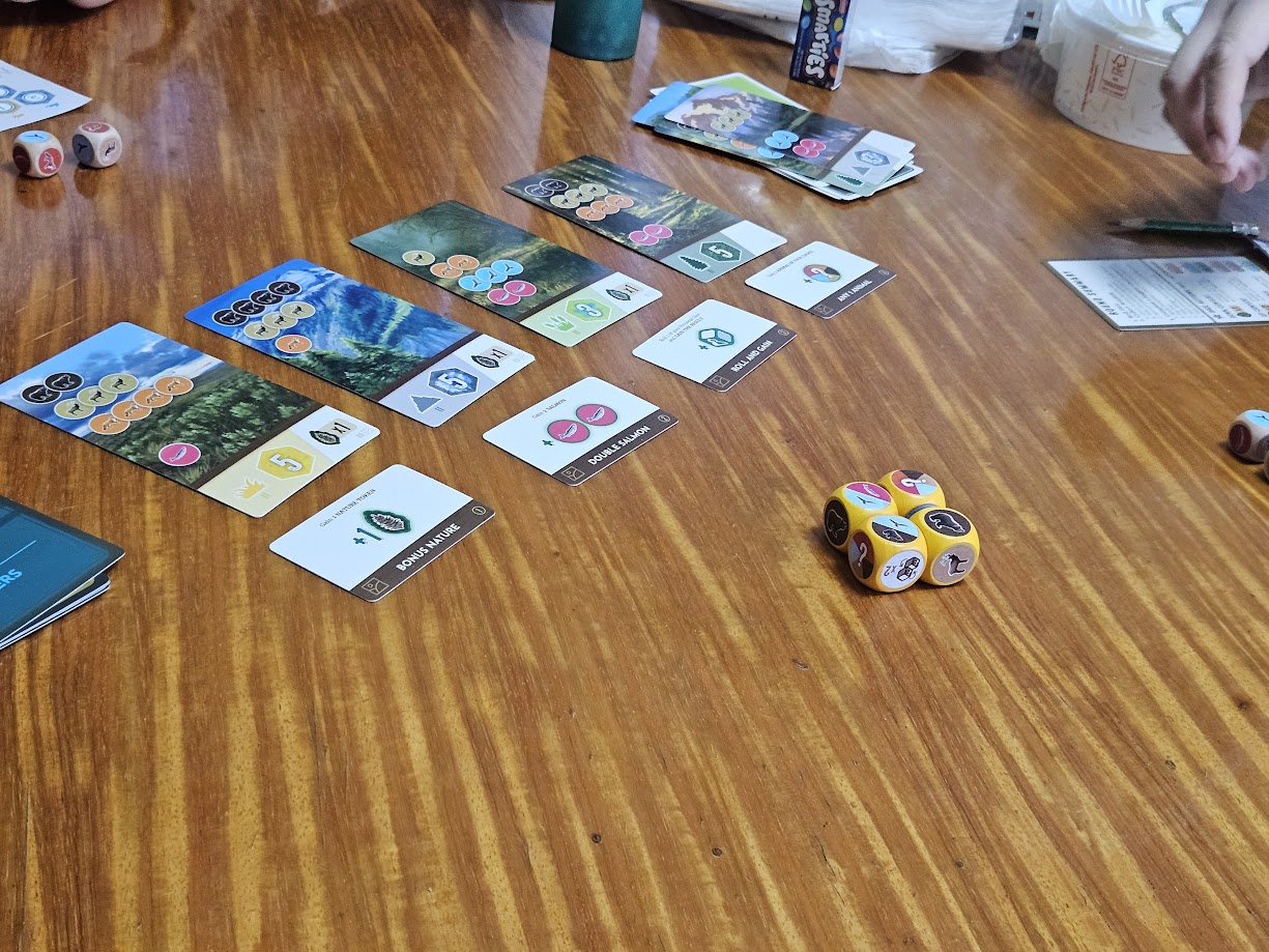 Gameplay photo of the board game Cascadia: Rolling Hills featuring various components and board state.