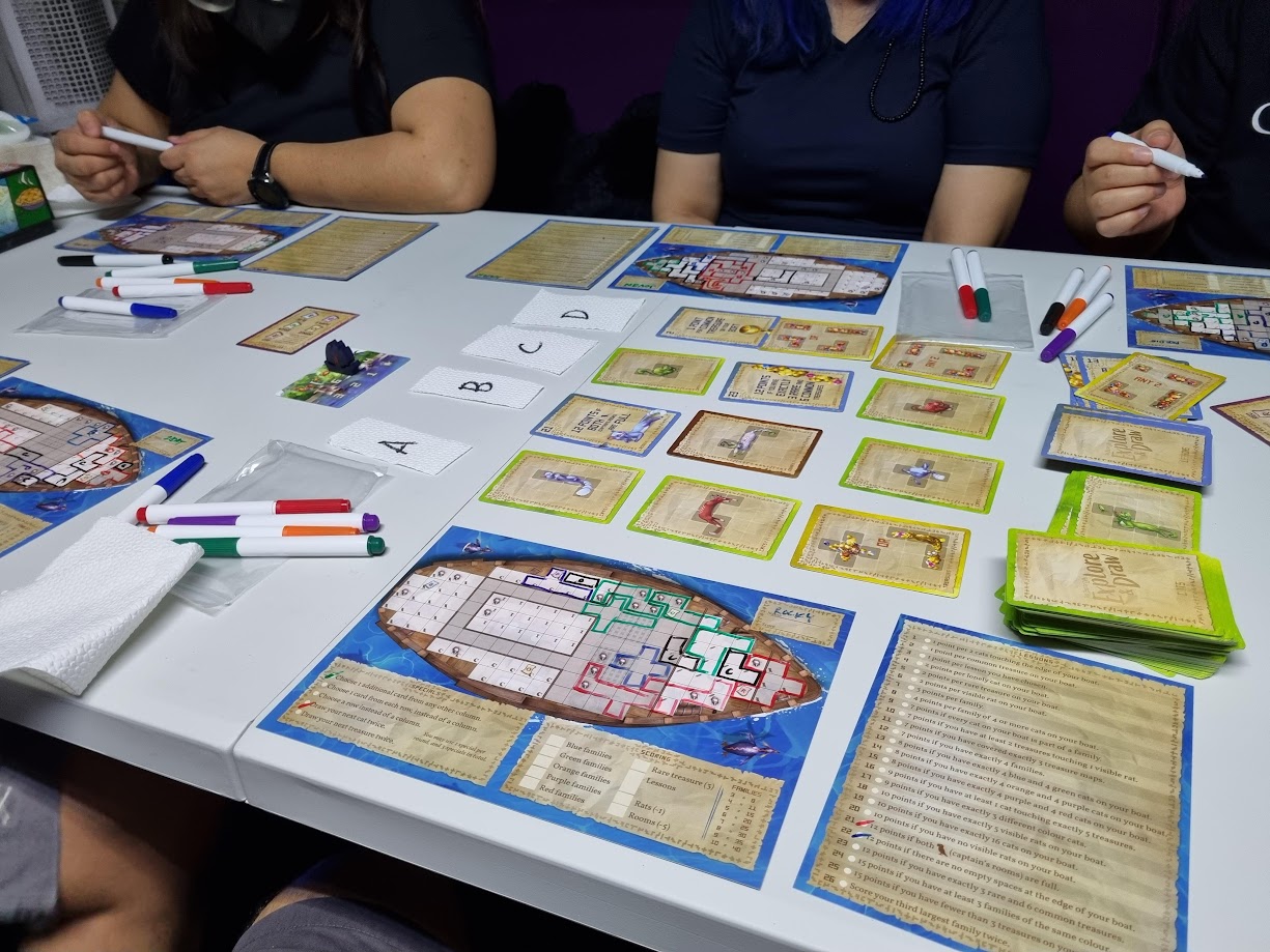 Gameplay photo of the board game The Isle of Cats: Explore & Draw featuring various components and board state.