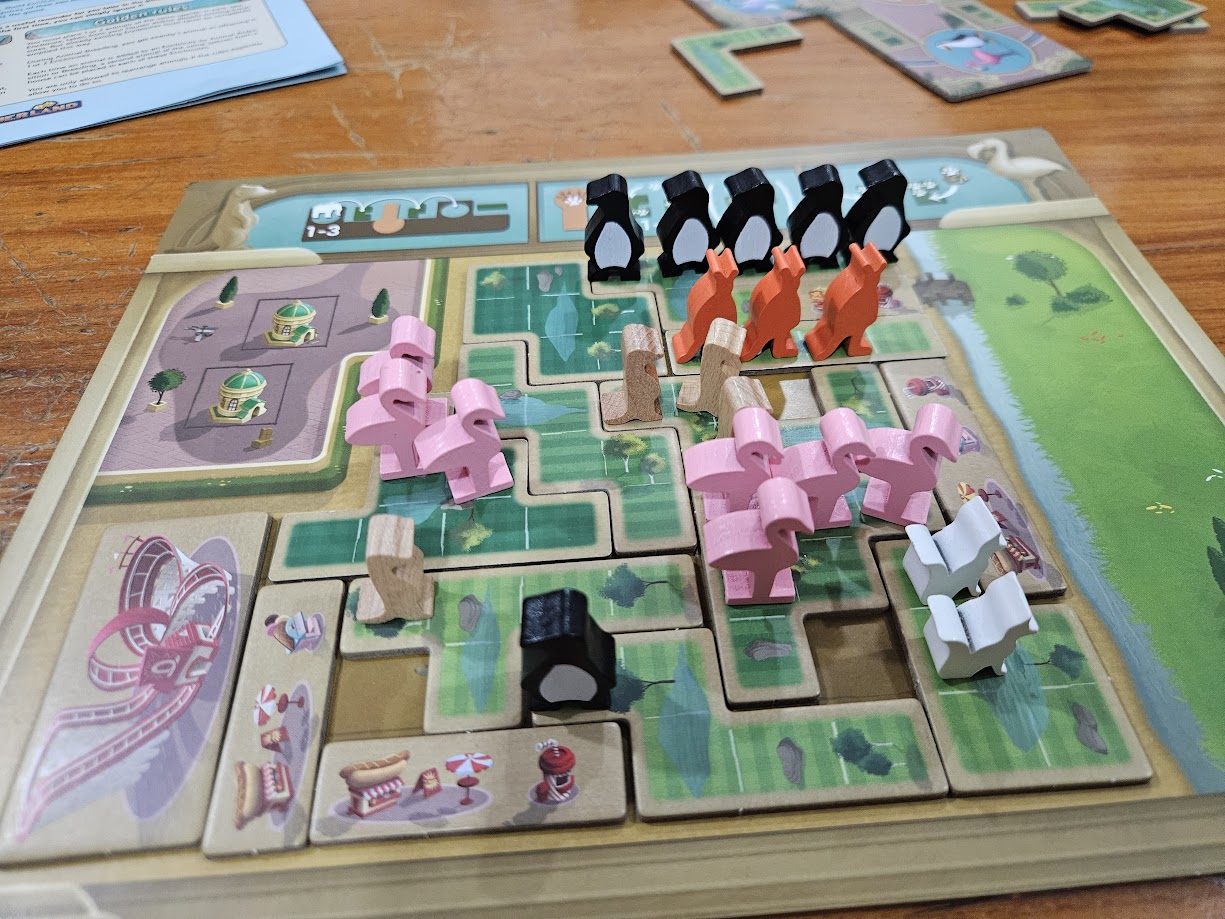Gameplay photo of the board game New York Zoo featuring various components and board state.