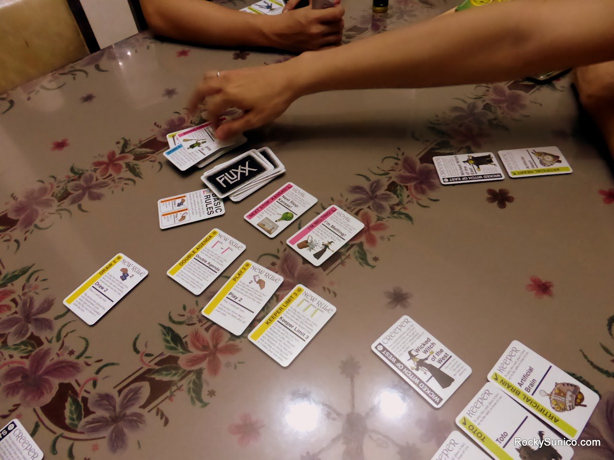 Gameplay photo of the board game Oz Fluxx featuring various components and board state.