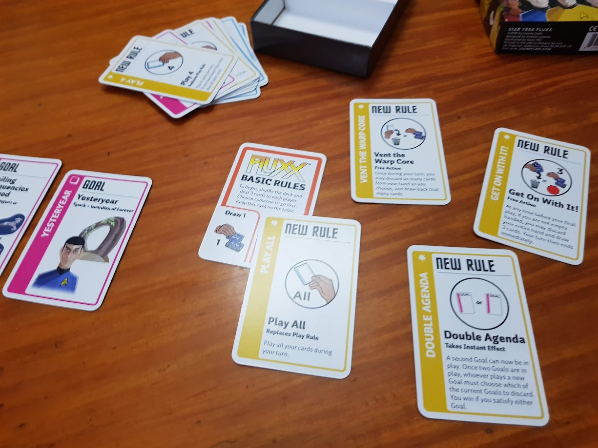 Gameplay photo of the board game Star Trek Fluxx featuring various components and board state.