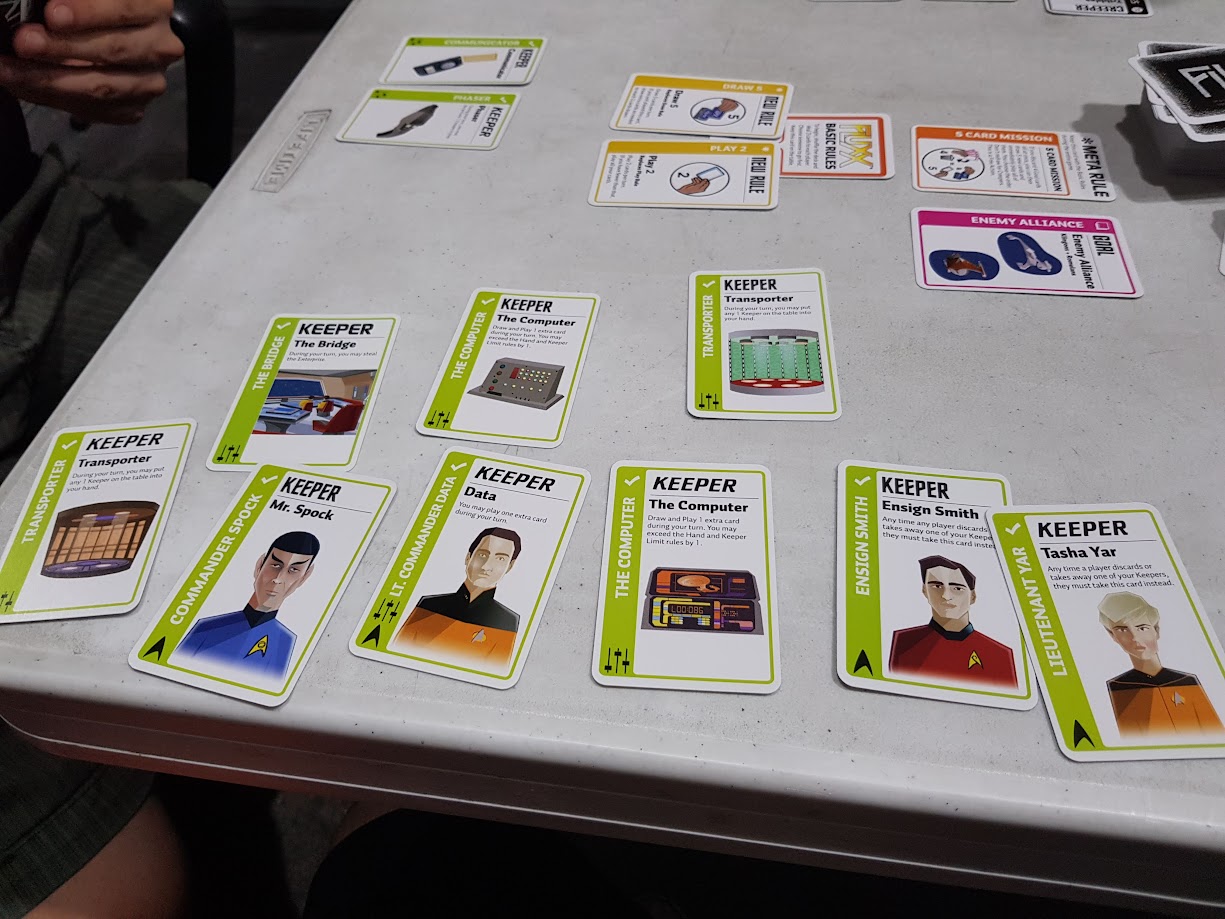 Gameplay photo of the board game Star Trek: The Next Generation Fluxx featuring various components and board state.